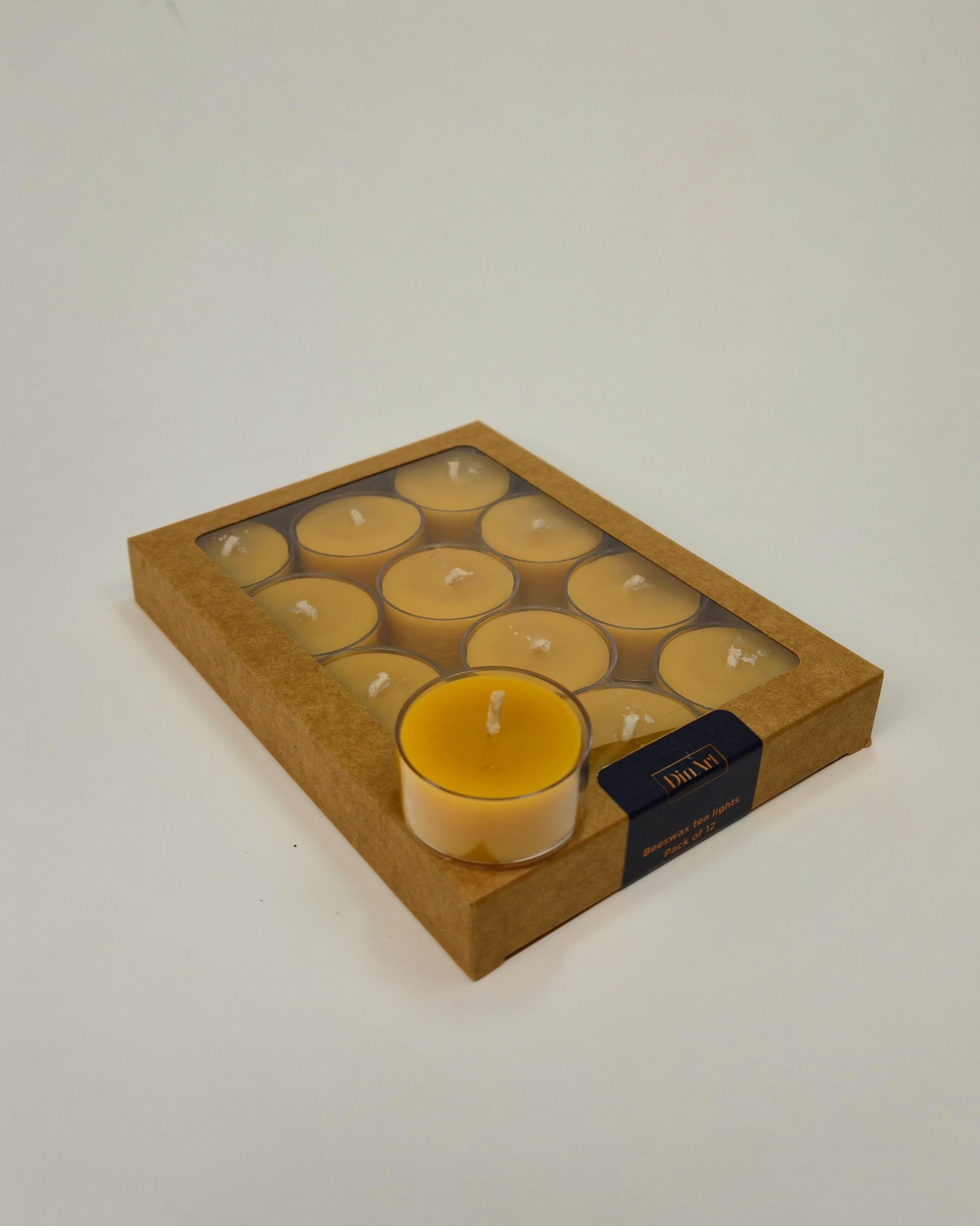 Box of beeswax candles with a single candle on a white background
